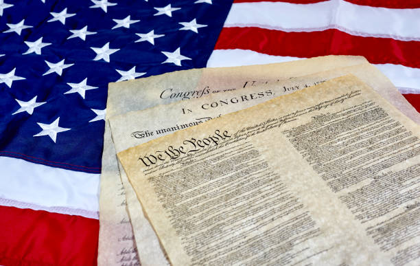 Image of the U.S. Constitution on American flag background.