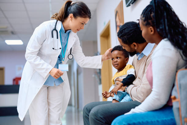 Pediatrician with medical interpreter assisting a family during a consultationjpg